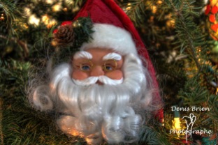 Close up of decoration of Santa Claus face with glasses in a Christmas tree
